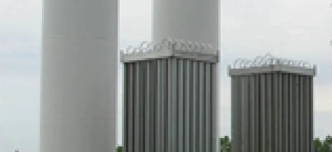 A steel cylinder storage tank made of composite material in an industrial setting. Engineering and industry concept with steel and aluminium silo.