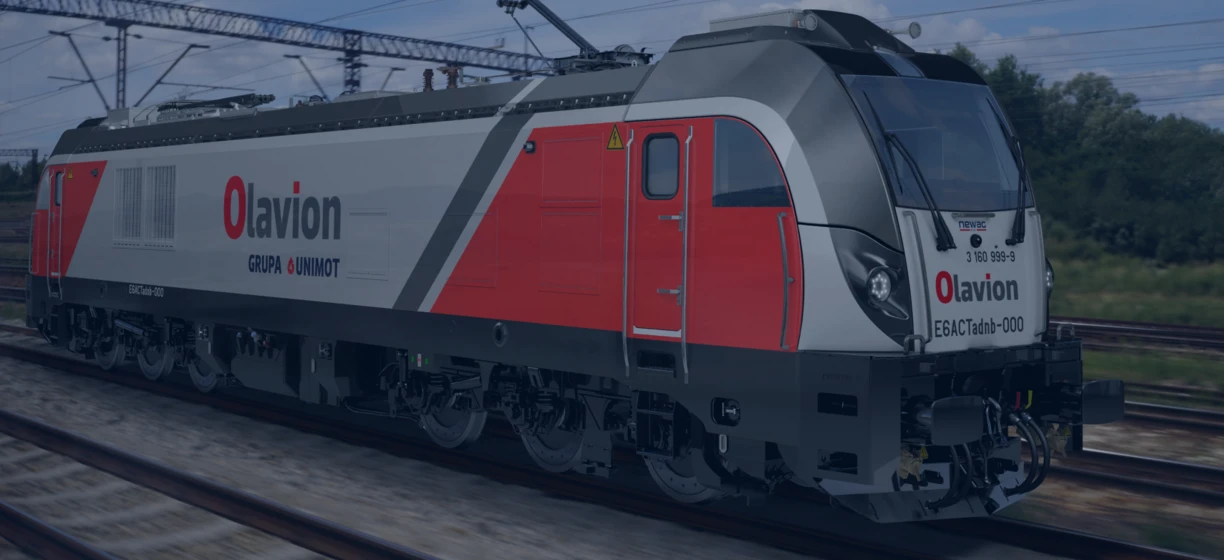 Electric locomotive rolling on the track, with windscreen wipers and headlamp on. ESACTadb-000 in focus.